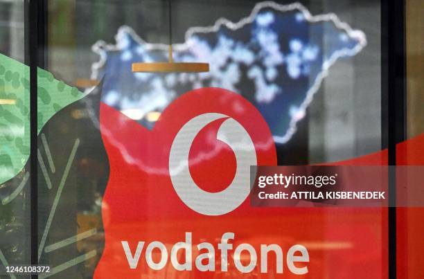 The logo of mobile operator Vodafone is seen at the company's headquarters while a map of Hungary is seen in the background, in Budapest on January...