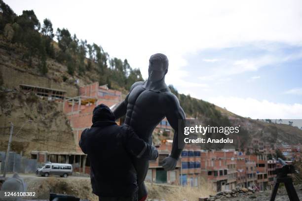 Sculptor Ramiro Sirpa holds a sculpture of Superman in his workshop in La Paz, Bolivia on December 22, 2022. Ramiro Sirpa known as "the sculptor of...