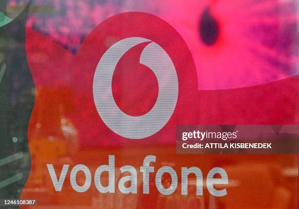 The logo of mobile operator Vodafone is seen on a window at the company's headquarters in Budapest on January 9, 2022. - Vodafone announced on...