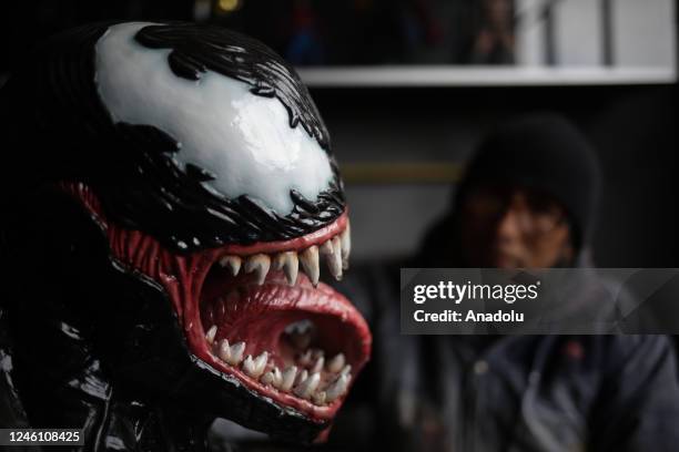 Sculptor Ramiro Sirpa looks at his sculpture of the character Venom from the Marvel universe made in his workshop in La Paz, Bolivia on December 22,...