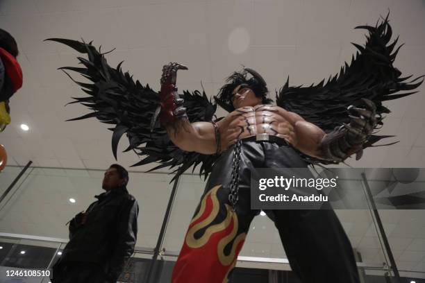 Man walks next to a sculpture of Jin from the game Tekken that is part of the "Mutante" exhibition by sculptor Ramiro Sirpa in La Paz, Bolivia on...
