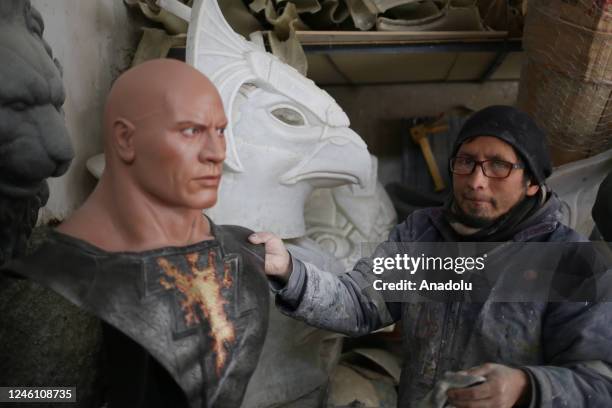 Ramiro Sirpa cleans some fiberglass sculptures in his workshop in La Paz, Bolivia on December 22, 2022. Ramiro Sirpa known as "the sculptor of...