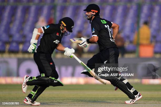 New Zealand's Daryl Mitchell and his teammate Tom Latham run between the wickets during the first one-day international cricket match between...