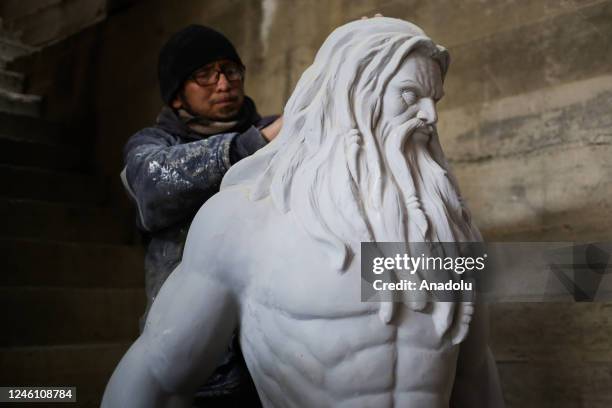 Sculptor Ramiro Sirpa cleans a sculpture of Zeus made in his workshop in La Paz, Bolivia on December 22, 2022. Ramiro Sirpa known as "the sculptor of...