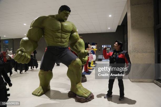 Man stands in front of the more than 3 meter sculpture of the Hulk at the "Mutante" exhibition by sculptor Ramiro Sirpa in La Paz, Bolivia on...