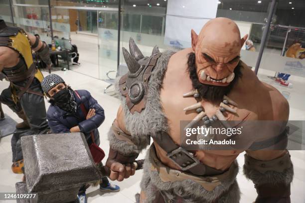 Man looks at the sculpture of a War Craft Orc at the "Mutante" exhibition by sculptor Ramiro Sirpa in La Paz, Bolivia on December 22, 2022. Ramiro...