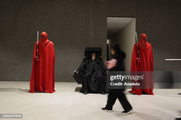 Woman walks in front of Star Wars characters at the "Mutante" exhibition by sculptor Ramiro Sirpa in La Paz, Bolivia on December 22, 2022. Ramiro...