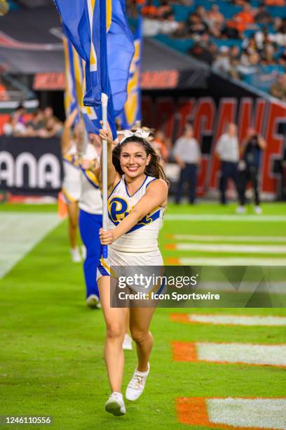 Pittsburgh cheerleaders smile as they carry flags in end zone as they celebrate Pittsburgh scoring a touchdown during an college football game...