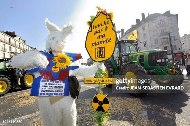 Placard is displayed near a tractor during a demonstration to protest against the international airport building project in Notre-Dame-des-Landes, on...