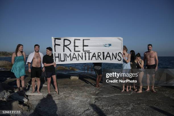 Humanitarians led by Sean Binder and Nassos Karakitsos are swimming by Mytilene's Statue of Liberty one day before their trial begins at the Court of...