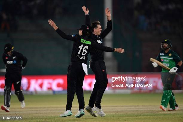 New Zealand's Michael Bracewell celebrates with his teammate Finn Allen after taking the wicket of Pakistan's Imam-ul-Haq during the first one-day...