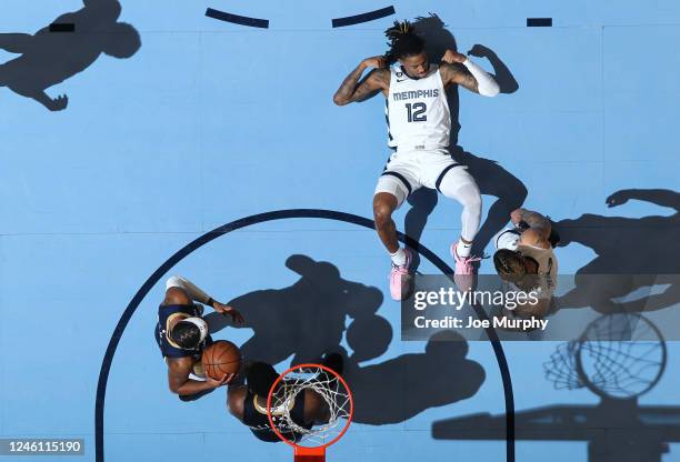 Ja Morant of the Memphis Grizzlies flexes and celebrates on the court against the New Orleans Pelicans on December 31, 2022 at FedExForum in Memphis,...