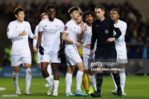 Arsenal players appeal for a penalty surrounding Referee David Coote during the Emirates FA Cup Third Round match between Oxford United and Arsenal...