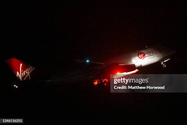 Cosmic Girl, a Boeing 747-400 aircraft carrying the LauncherOne rocket under its left wing, takes off from Cornwall Airport Newquay on January 9,...