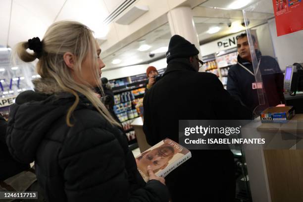 People queue to buy the book "Spare", by Britain's Prince Harry, Duke of Sussex during a special midnight opening event for the release of the...