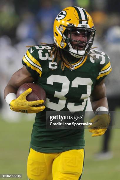 Green Bay Packers running back Aaron Jones runs with the ball during a game between the Green Bay Packers and the Detroit Lions at Lambeau Field on...