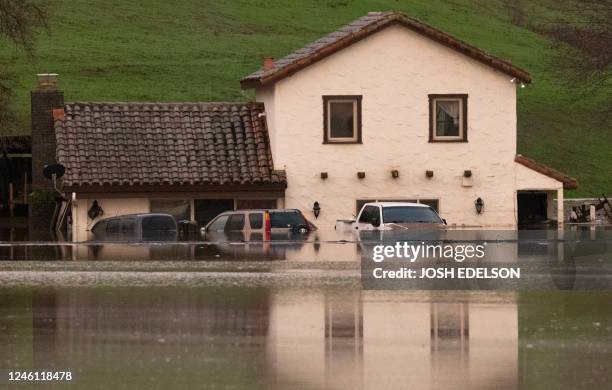 Flooded house is seen partially underwater in Gilroy, California, on January 09, 2023. - Heavy rain lashed water-logged California Monday, with...