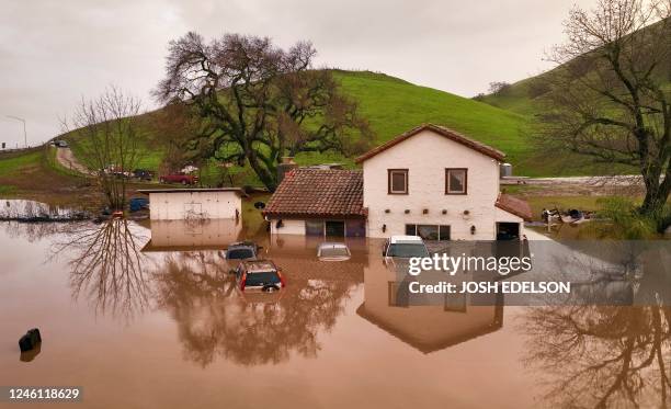 Flooded house is seen partially underwater in Gilroy, California, on January 09, 2023. - Heavy rain lashed water-logged California Monday, with...