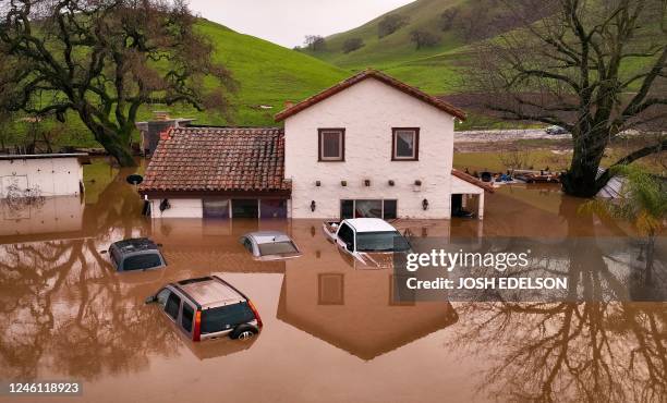 Flooded house is seen partially underwater in Gilroy, California, on January 09, 2023. - Heavy rain lashed water-logged California Monday, with...