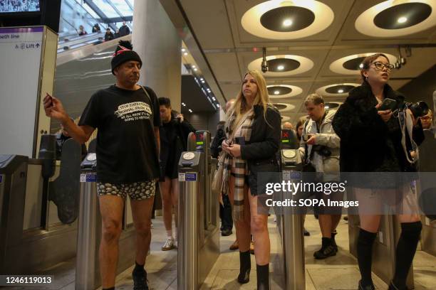 Participants with no trousers seen at a ticket barrier in central London. Over 100 participants took part in the annual No Trousers Tube Ride event...
