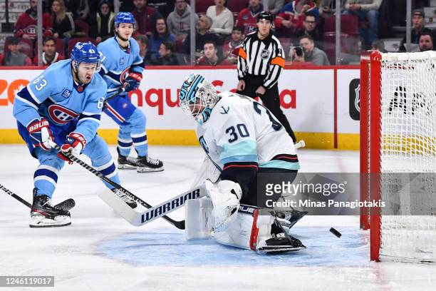 Evgenii Dadonov of the Montreal Canadiens tips the puck wide of goaltender Martin Jones of the Seattle Kraken during the second period at Centre Bell...
