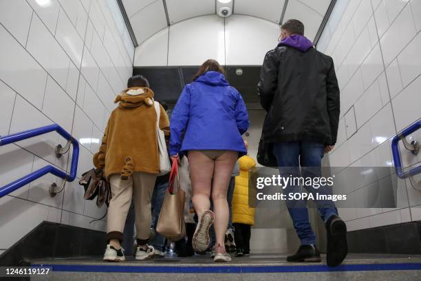 One participant with no trousers walks with other commuters at an underground station. Over 100 participants took part in the annual No Trousers Tube...