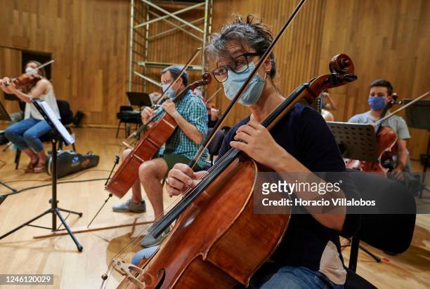 Members of the Cascais & Oeiras Chamber Orchestra wear protective masks during a rehearsal under conductor Maestro Nikolay Lalov in the Auditório da...