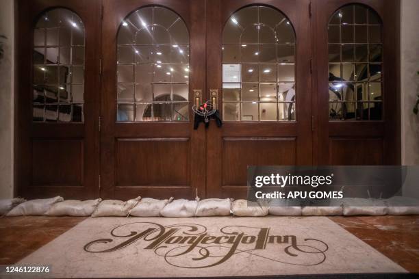 Sand bags are seen at the door of the Montecito Inn hotel closed under mandatory evacuation due heavy rainfall in the area on January 9 in Montecito,...