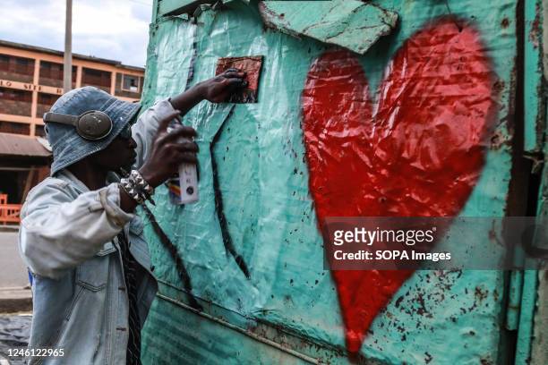 Graffiti artist paints a love mural on a makeshift shelter during a reggae concert to commemorate Nakuru's inclusion in the UNESCO Creative Cities...