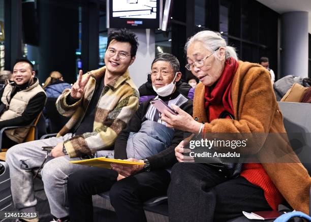 Passengers sit in the boarding lounge before the first flight from Istanbul to Guangzhou as China re-opens its borders for the first time since March...