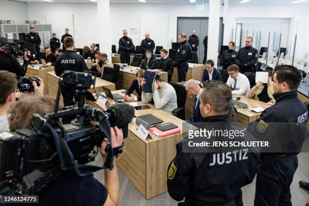 Defendants sit next to their lawyers at the Higher Regional Court in Dresden, eastern Germany on January 10, 2023 prior to a hearing in the trial...