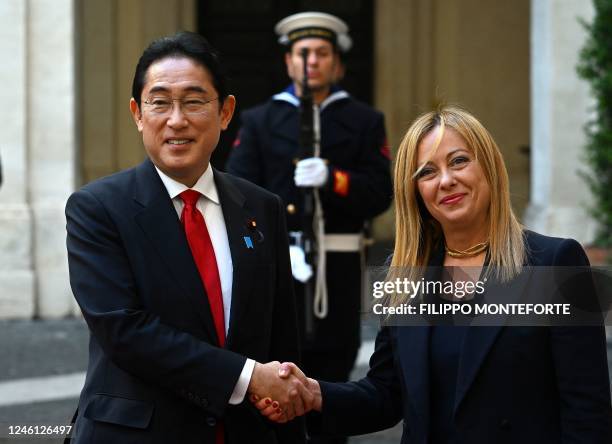 Italy's Prime Minister Giorgia Meloni shakes hands with Japan's Prime Minister Fumio Kishida before their meeting on January 10, 2023 in Rome's...