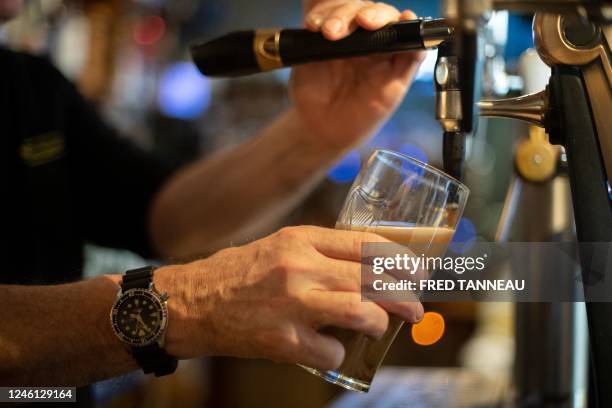 Bartender pours a daft beer in a bar in Brest, western France , on January 10, 2023. Dry January is the tradition of abstaining from consuming...