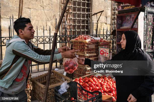 Vendor sells fresh tomatoes at a food market in the Al-Khalifa district of Cairo, Egypt, on Saturday, Jan. 7, 2023. Egypts urban inflation...