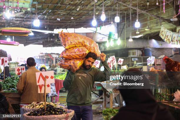 Vendor carries bags of carrots at Al-Monira food market in the Imbaba district of Giza, Egypt, on Saturday, Jan. 7, 2023. Egypts urban inflation...