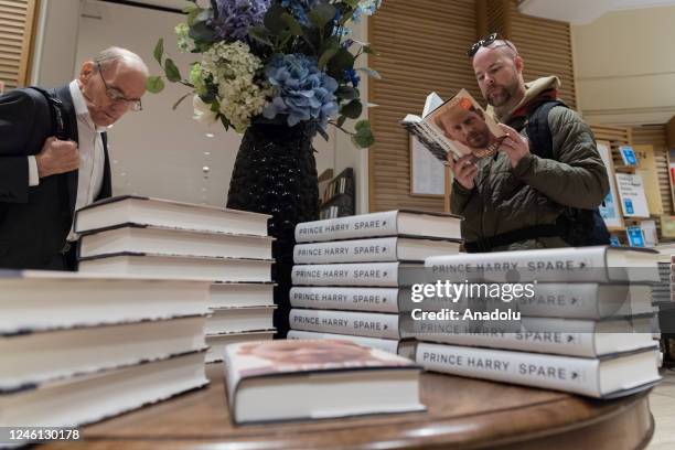 Customer reads Prince Harry's memoir 'Spare' at a bookshop in central London on the day of its official release in London, United Kingdom on January...