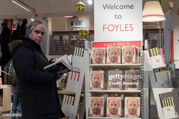 Customer reads Prince Harry's memoir 'Spare' at a bookshop in central London on the day of its official release in London, United Kingdom on January...