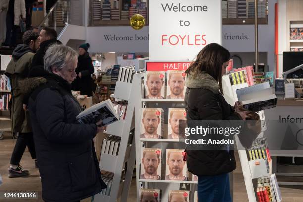 Customers read Prince Harry's memoir 'Spare' at a bookshop in central London on the day of its official release in London, United Kingdom on January...