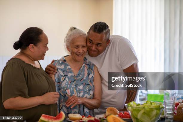 cuddling in the kitchen - pacific islander stock pictures, royalty-free photos & images