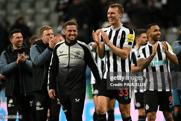 Newcastle United's English defender Dan Burn applauds fans on the pitch after the English League Cup quarter final football match between Newcastle...