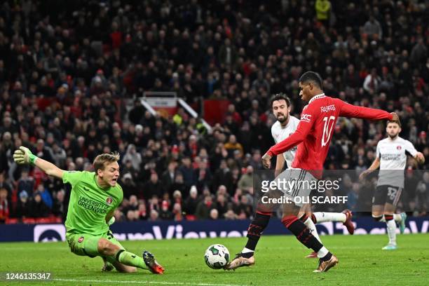 Manchester United's English striker Marcus Rashford scores their second goal past Charlton's Australian goalkeeper Ashley Maynard-Brewer during the...