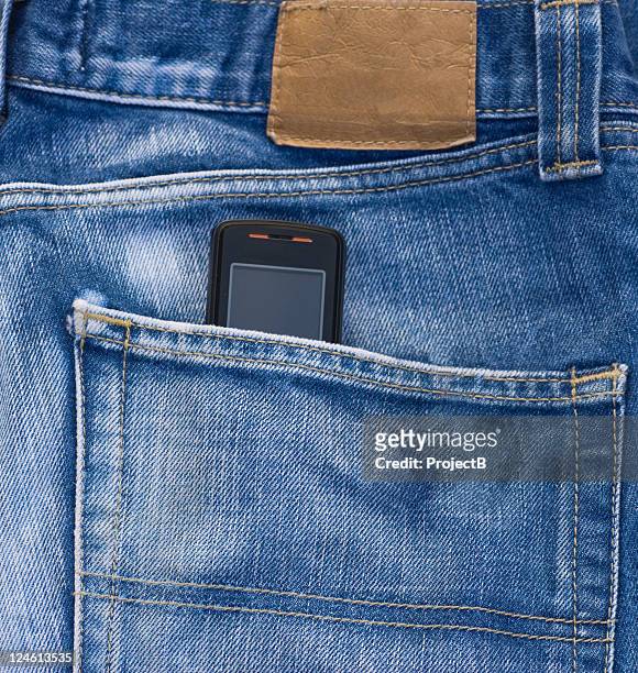 cell phone in jeans pocket - phone in back pocket stock pictures, royalty-free photos & images
