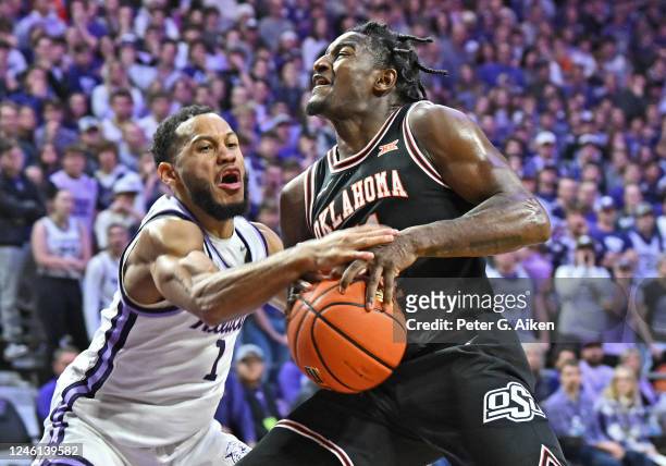 Markquis Nowell of the Kansas State Wildcats reaches in for the ball against John-Michael Wright of the Oklahoma State Cowboys in the first half at...