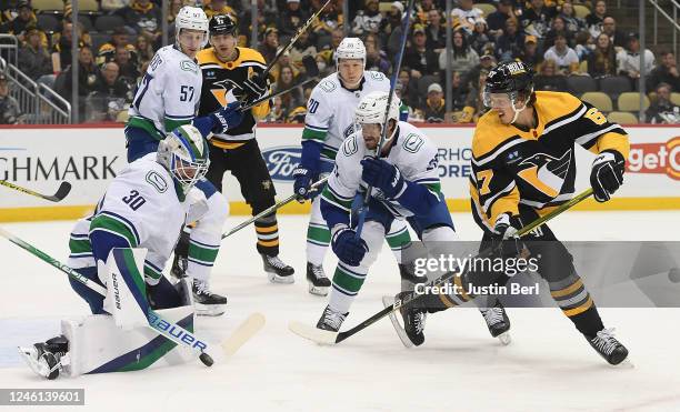 Spencer Martin of the Vancouver Canucks makes a save on a shot by Rickard Rakell of the Pittsburgh Penguins in the first period at PPG PAINTS Arena...