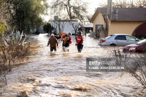 San Diego firefighters rescue dogs from a flooded home in Merced, California, on January 10, 2023. - Relentless storms were ravaging California again...