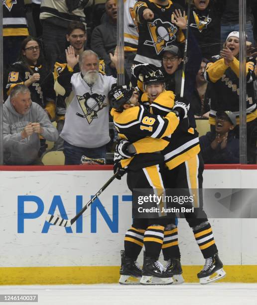 Evgeni Malkin of the Pittsburgh Penguins celebrates his goal with Jason Zucker in the second period against the Vancouver Canucks at PPG PAINTS Arena...