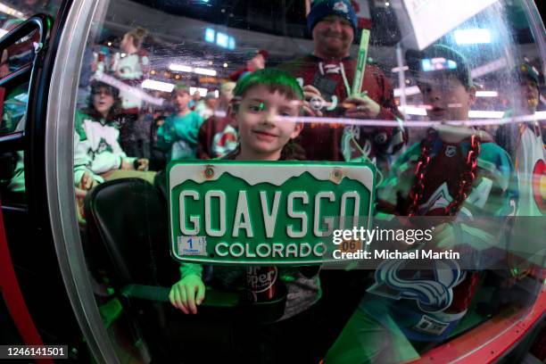 Young fan of the Colorado Avalanche displays a Colorado license plate prior to the game against the Florida Panthers at Ball Arena on January 10,...