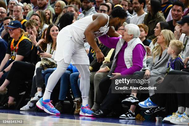 Donovan Mitchell of the Cleveland Cavaliers speaks to former Utah Jazz owner Gail Miller during the first half against the Jazz at Vivint Arena on...