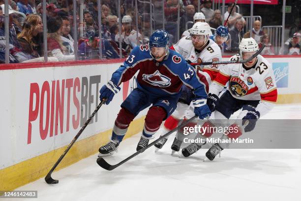 Darren Helm of the Colorado Avalanche skates against Sam Bennett and Carter Verhaeghe of the Florida Panthers at Ball Arena on January 10, 2023 in...