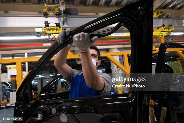 An Iranian worker assembles a vehicle at a production line of Iran Khodro Automaker Company , 13 km west of Tehran on January 10, 2023.